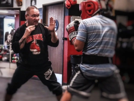 Members participating in boxing fitness training during gym classes in Lake Elsinore at Supreme Boxer Boxing Club